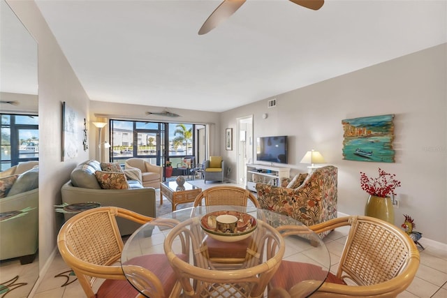 tiled dining area with ceiling fan