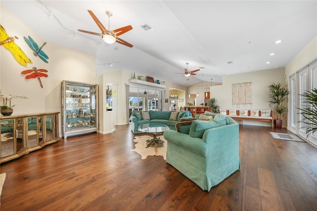 living room featuring vaulted ceiling, ceiling fan, and dark hardwood / wood-style floors