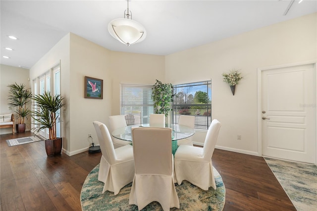 dining space with dark hardwood / wood-style floors