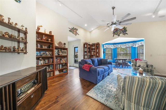 living room with high vaulted ceiling, dark hardwood / wood-style flooring, ceiling fan, and track lighting