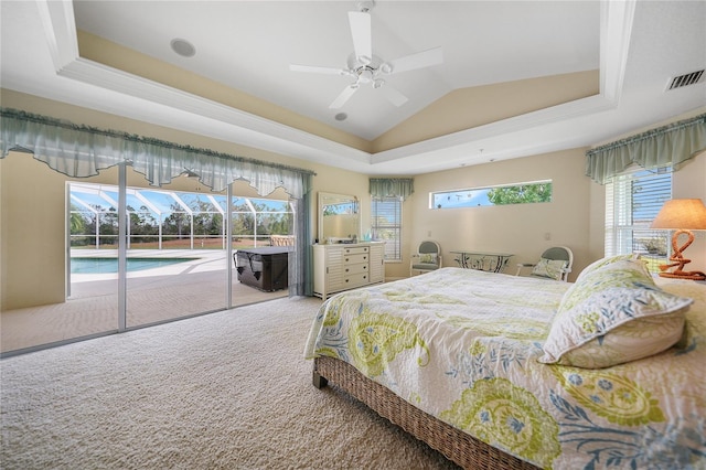 bedroom with light carpet, a tray ceiling, access to exterior, and ceiling fan