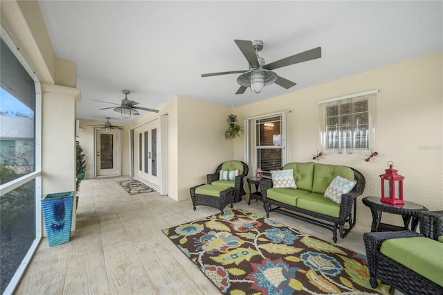 living room featuring ceiling fan and light wood-type flooring