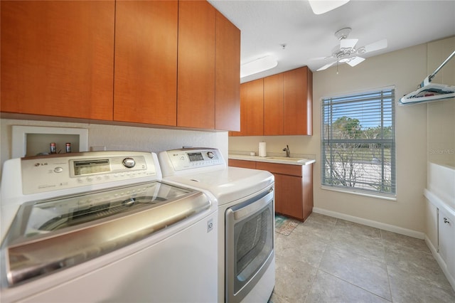 laundry area featuring light tile floors, separate washer and dryer, ceiling fan, cabinets, and sink