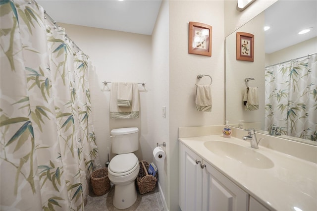 bathroom with tile floors, large vanity, and toilet