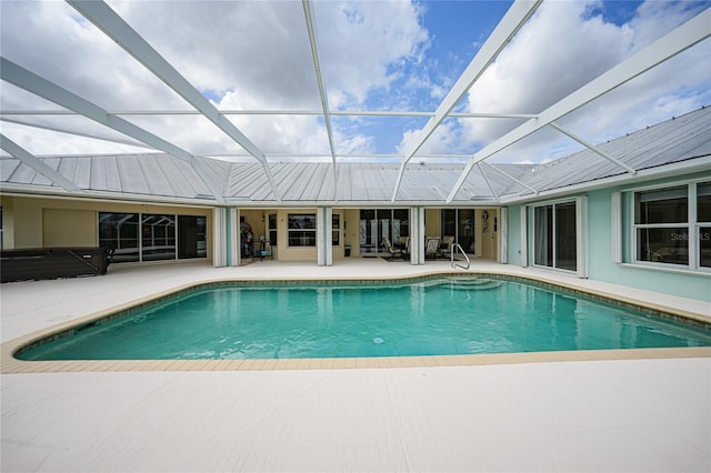 view of swimming pool featuring a lanai and a patio