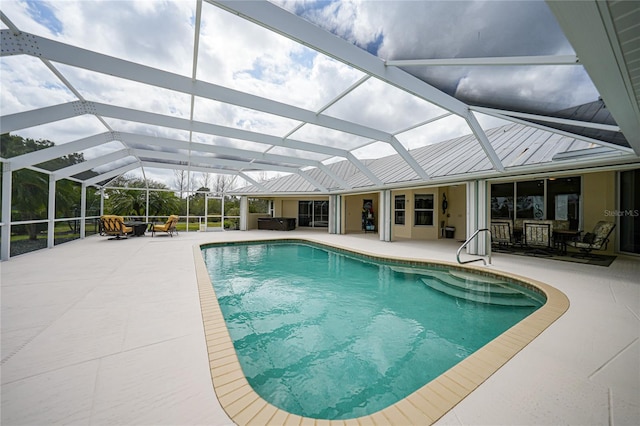 view of pool with a lanai and a patio