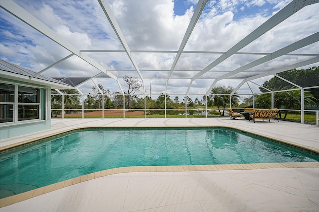 view of pool featuring a patio area and glass enclosure