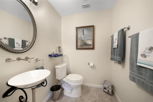 bathroom featuring toilet and tile floors