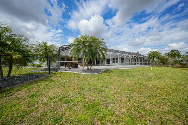 view of yard with a patio area, a pool, and glass enclosure