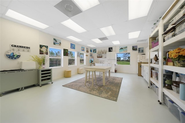 rec room with beverage cooler and a paneled ceiling