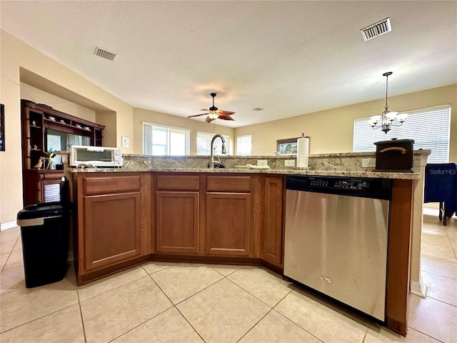 kitchen with hanging light fixtures, stainless steel dishwasher, a textured ceiling, light tile patterned floors, and ceiling fan with notable chandelier