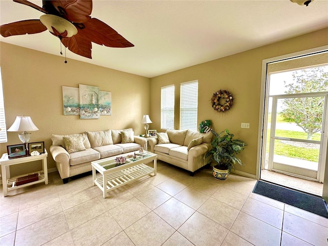 living room with ceiling fan, a wealth of natural light, and light tile patterned flooring