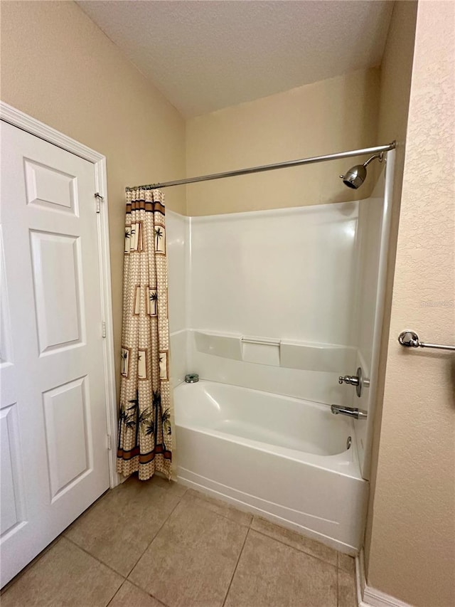 bathroom featuring tile patterned floors, a textured ceiling, and shower / tub combo with curtain