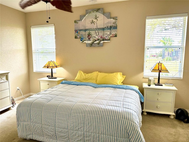 carpeted bedroom featuring ceiling fan