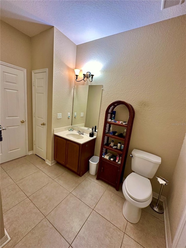 bathroom with tile patterned flooring, vanity, and toilet