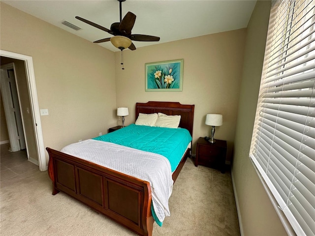 bedroom with ceiling fan and light colored carpet