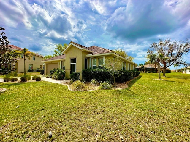 view of front of house with a front lawn and a garage