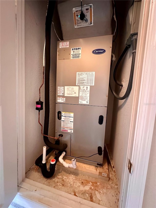 utility room featuring heating unit