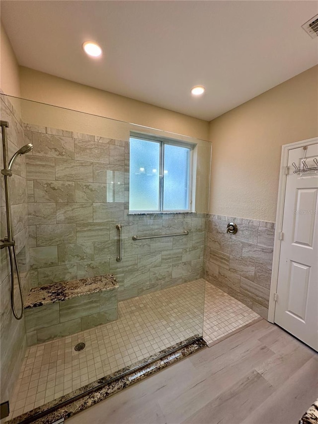 bathroom with wood-type flooring and walk in shower