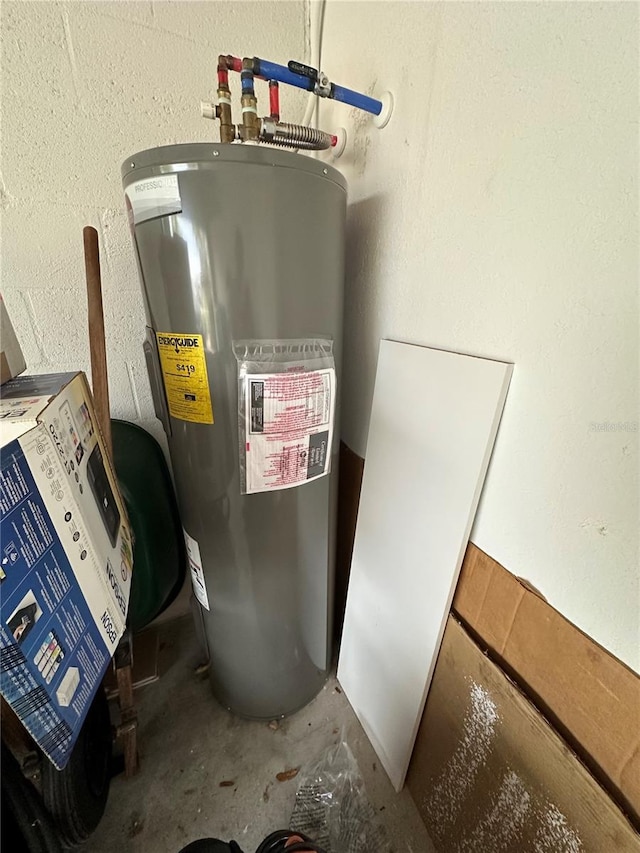 utility room featuring water heater