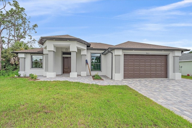 view of front of house featuring a garage and a front lawn