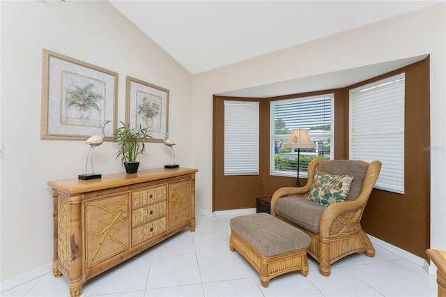 sitting room with light tile flooring and vaulted ceiling