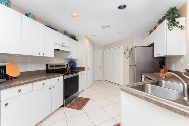 kitchen featuring white cabinets, tasteful backsplash, and stainless steel electric range oven