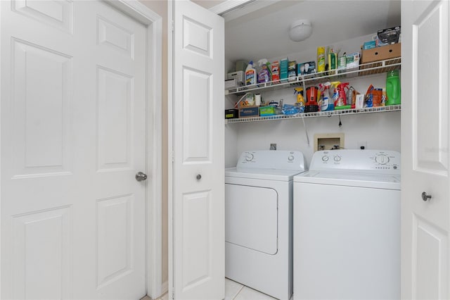 clothes washing area featuring light tile floors, washer hookup, hookup for an electric dryer, and washing machine and dryer