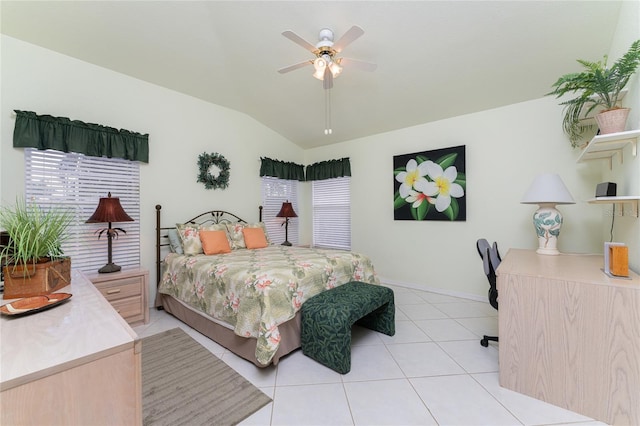 tiled bedroom featuring lofted ceiling and ceiling fan