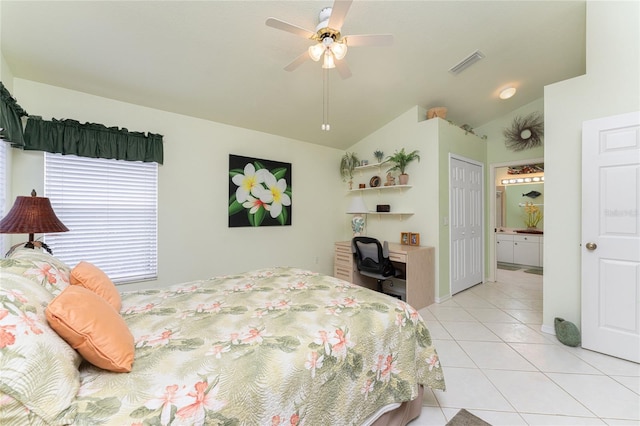 tiled bedroom featuring vaulted ceiling, a closet, and ceiling fan