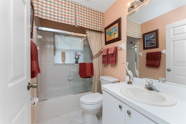 full bathroom featuring tile flooring, toilet, oversized vanity, and enclosed tub / shower combo