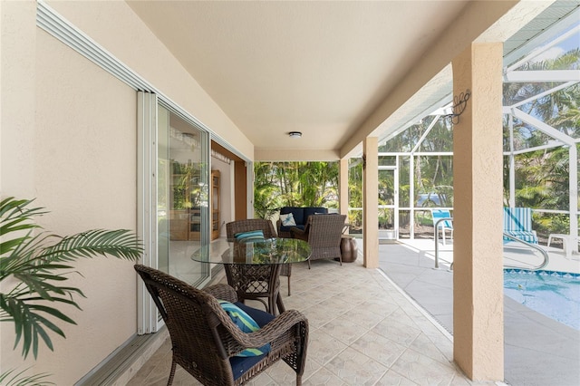 view of patio / terrace with an outdoor hangout area and glass enclosure