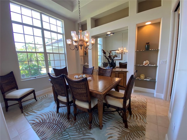 dining space with light tile patterned floors, a chandelier, and plenty of natural light