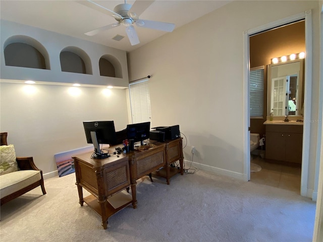 home office with sink, ceiling fan, and light colored carpet