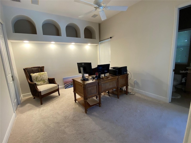 office area featuring light carpet and ceiling fan