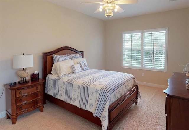 bedroom with ceiling fan and light carpet