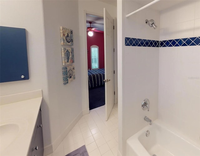 bathroom with ceiling fan, tiled shower / bath, vanity, and tile patterned flooring