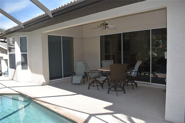 exterior space with glass enclosure and ceiling fan