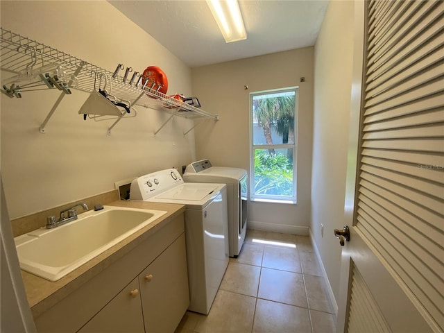 washroom with cabinets, light tile patterned flooring, sink, and independent washer and dryer