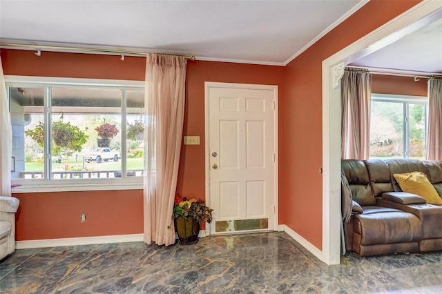 tiled entrance foyer featuring crown molding