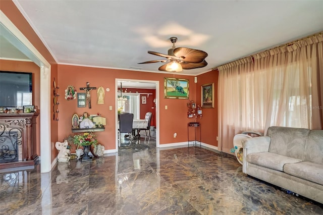 living room featuring dark tile floors, ornamental molding, and ceiling fan