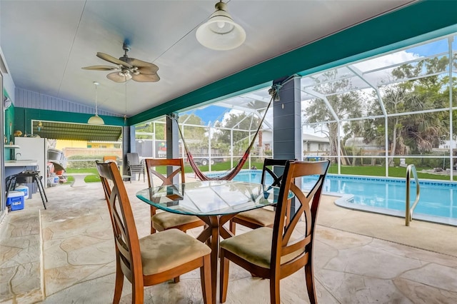 sunroom / solarium featuring ceiling fan and vaulted ceiling