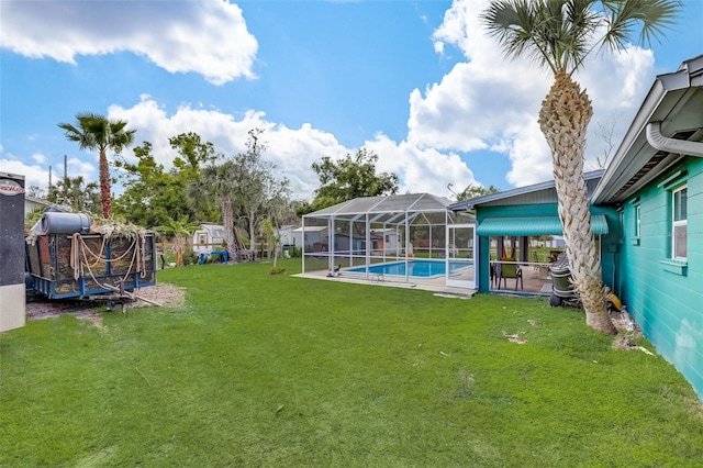 view of yard with a lanai and a fenced in pool