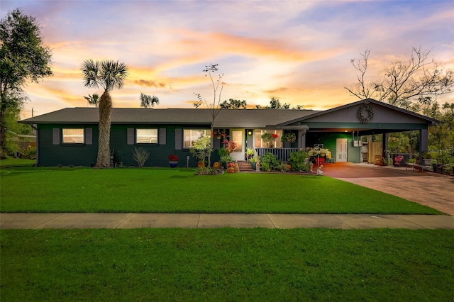 ranch-style home with a lawn and a carport