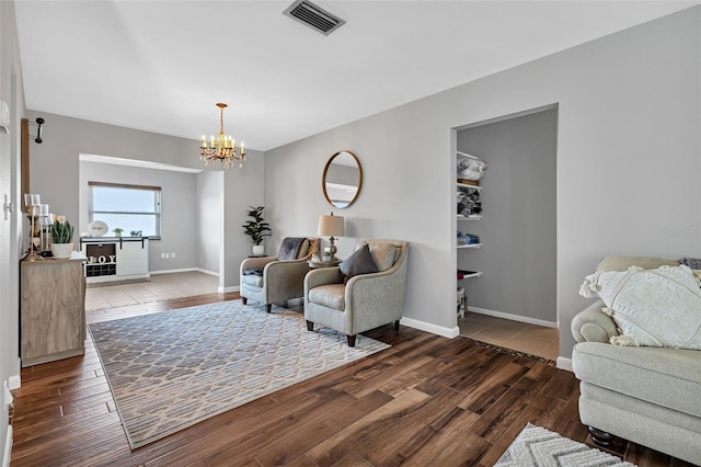 sitting room with an inviting chandelier and wood-type flooring