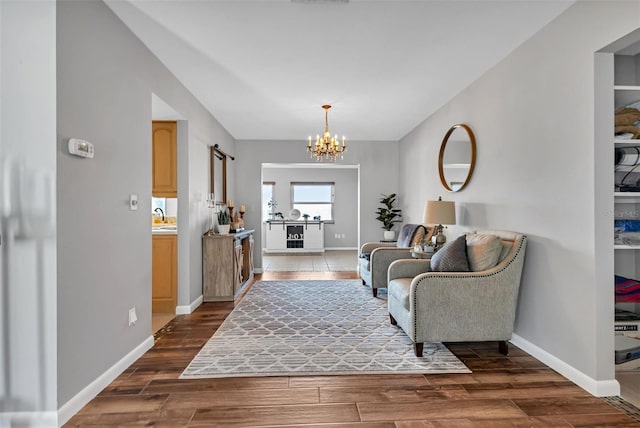 living room featuring a chandelier, dark hardwood / wood-style floors, and sink