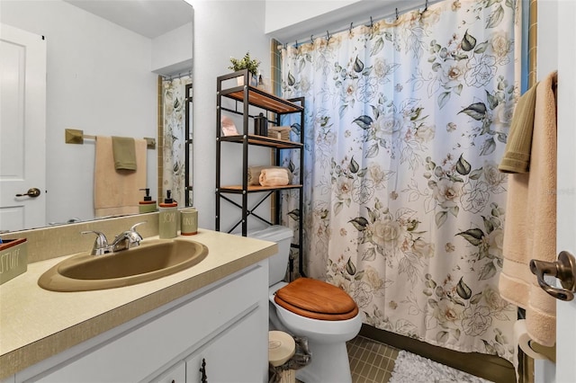 bathroom featuring toilet, tile floors, and vanity with extensive cabinet space