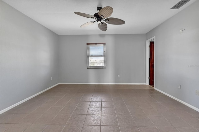 tiled spare room with ceiling fan