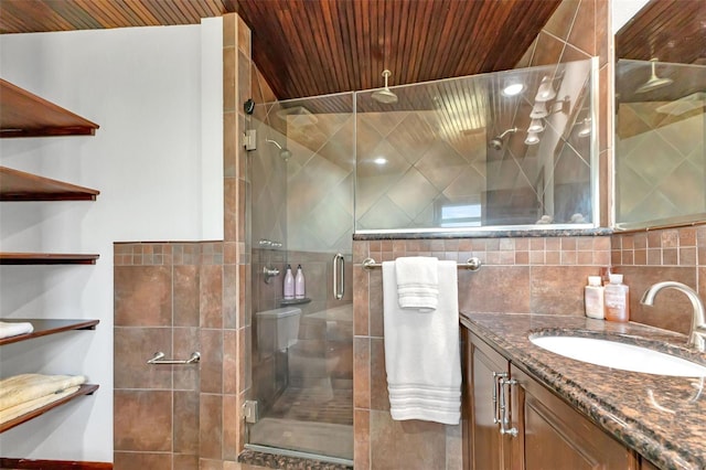 bathroom featuring tile walls, vanity, a shower with shower door, and wood ceiling