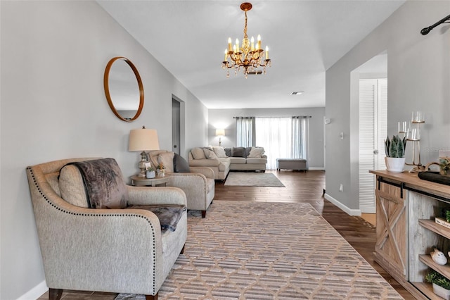 living room featuring a notable chandelier and dark hardwood / wood-style floors